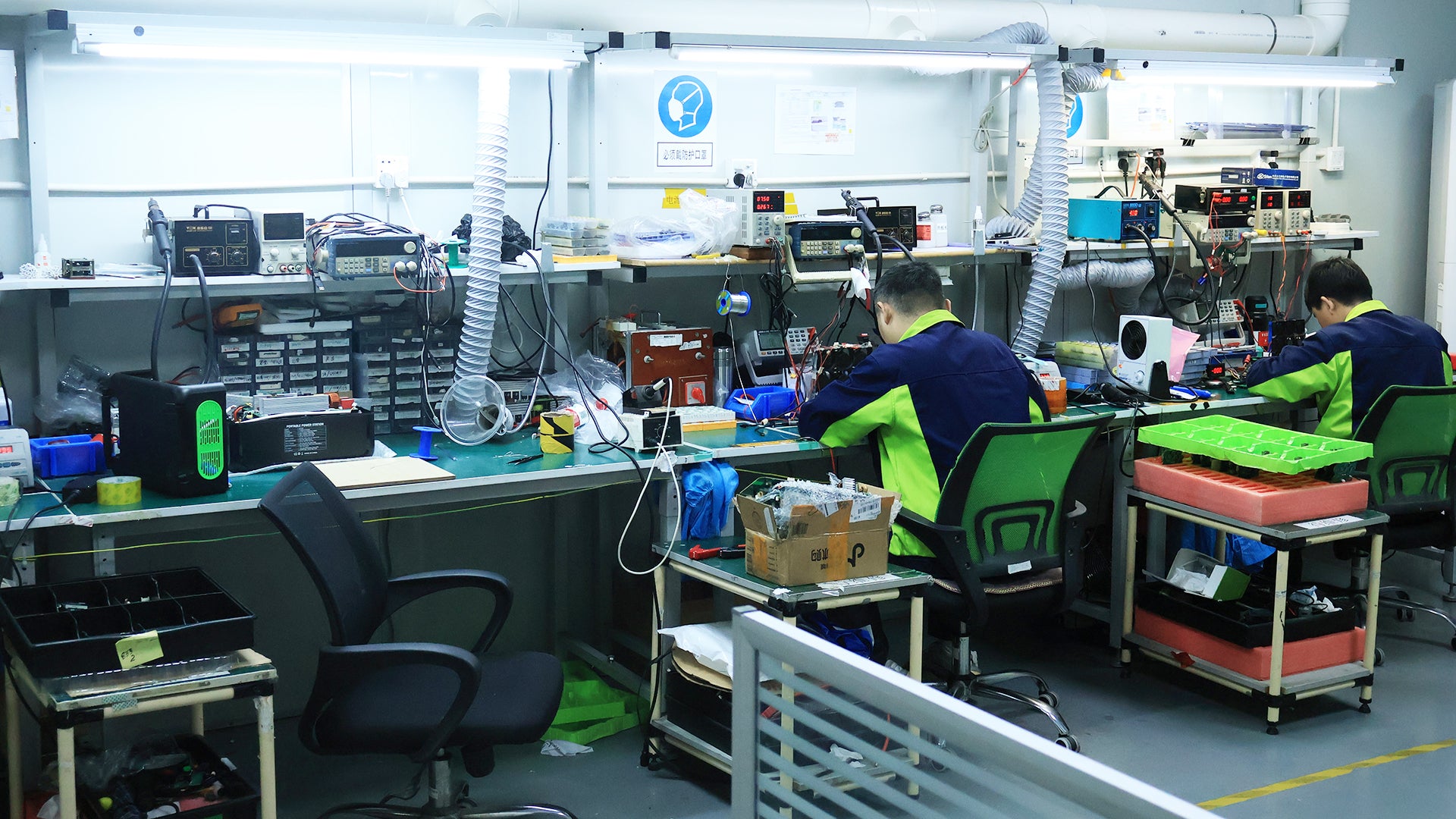 WEGREEN industrial R&D laboratory with engineers working on energy storage systems, representing mission-critical performance and professional-grade solutions
